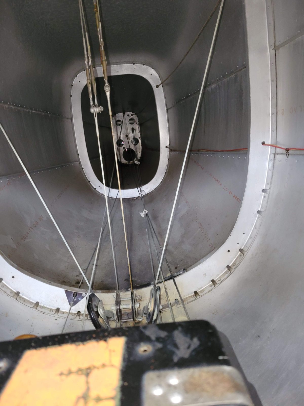 Inspecting control cables inside an aircraft tail cone