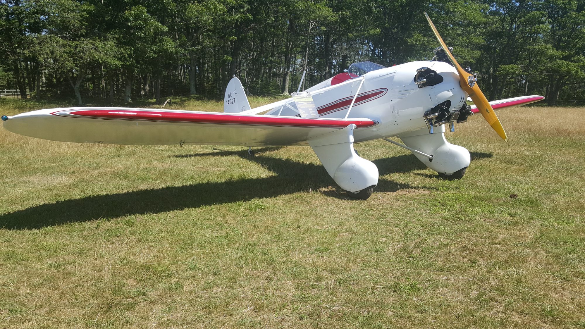 Classic light sport aircraft parked on a New England grass field